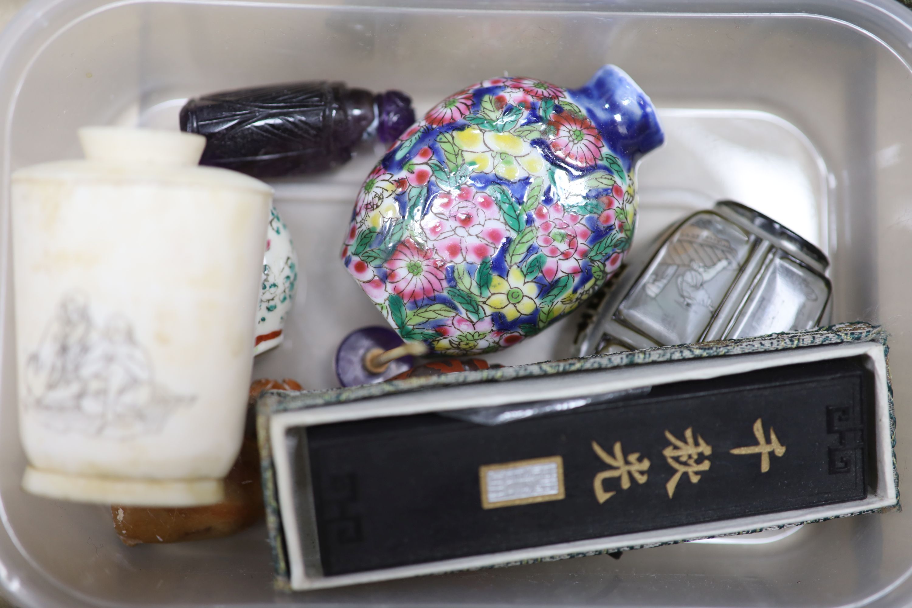 A collection of Chinese hardstone animals, collection of snuff bottles and small ornaments and two stands
